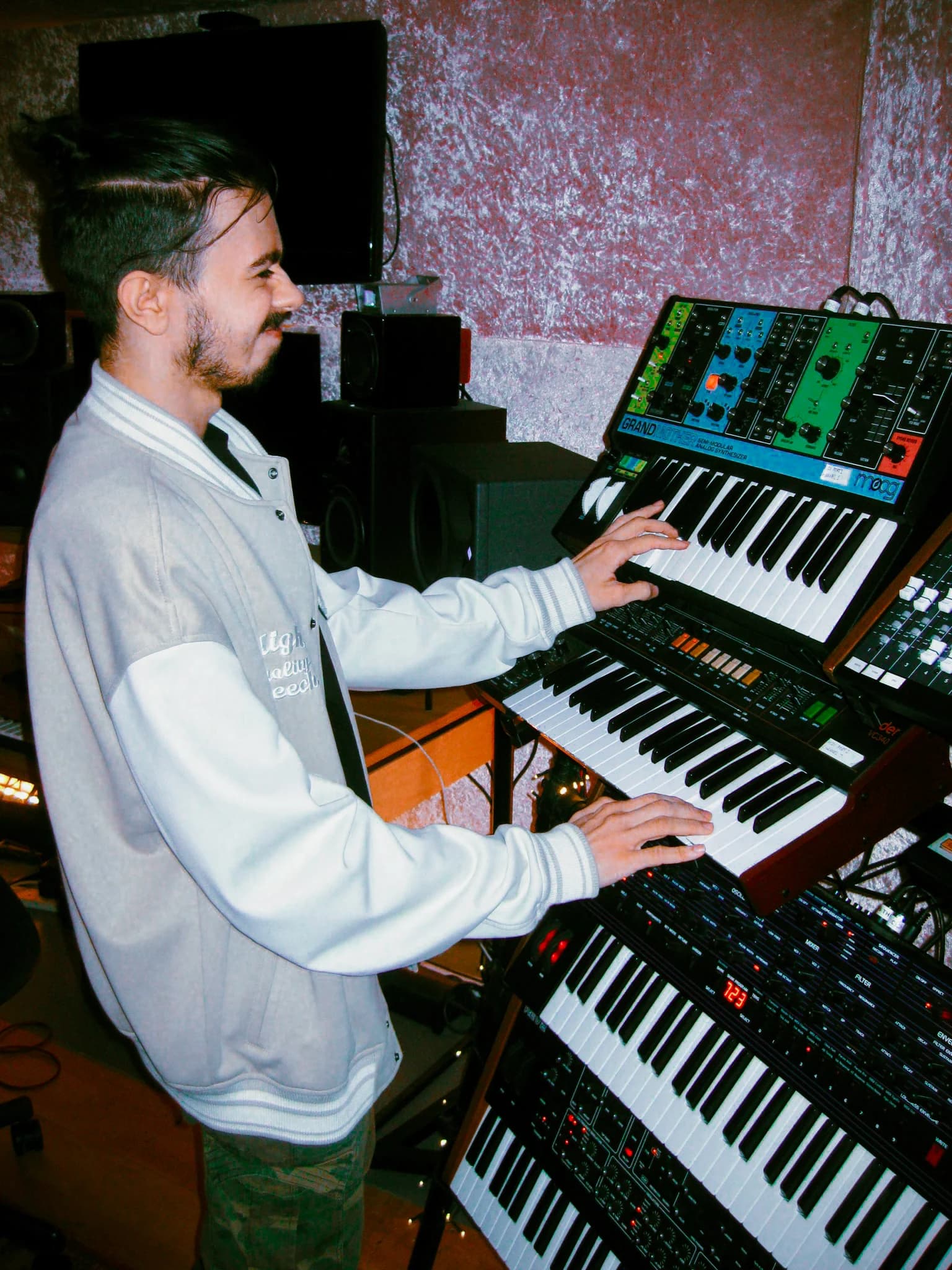 Cadyn Lewis playing synthesisers at REX Studio, photographed by Leela Rosa