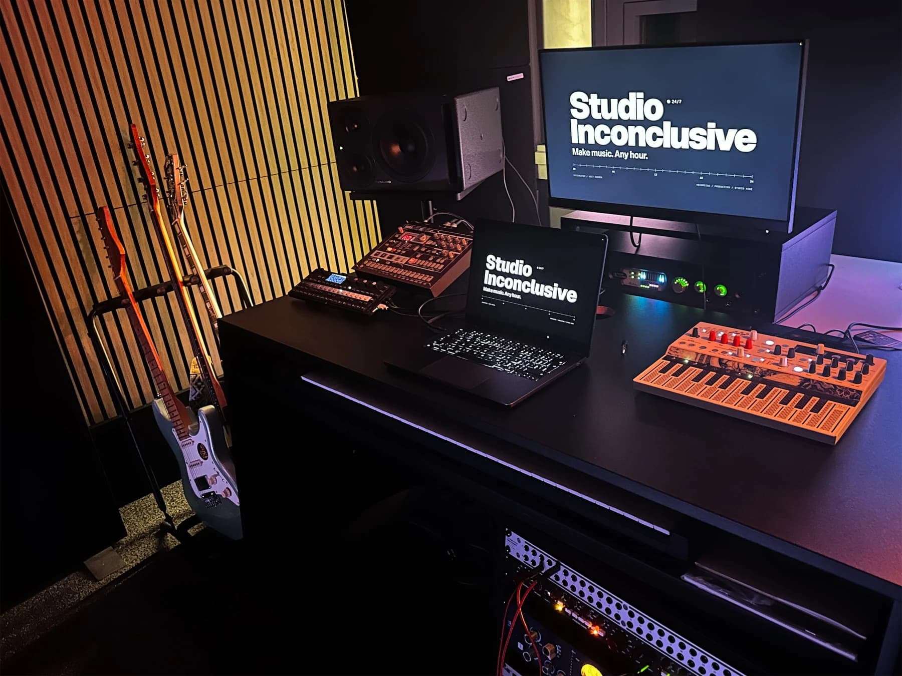Guitars beside the production desk and recording equipment at Studio Inconclusive in Chichester
